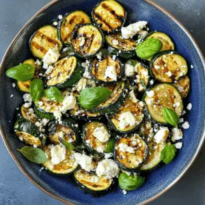 Get ready for a fresh and simple side dish with grilled zucchini topped with creamy feta and fragrant basil! This recipe highlights the natural flavors of zucchini while adding a delightful twist with feta cheese and aromatic herbs. Perfect for summer cookouts or as a tasty accompaniment to any meal. Save this for your next barbecue or gathering!