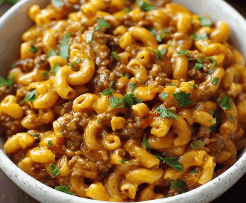 Delicious homemade chili mac dish featuring pasta, seasoned chili, and melted cheese served in a bowl