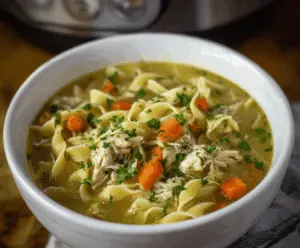 Creamy and hearty Crockpot Chicken Noodle Soup in a bowl, featuring tender chicken, noodles, vegetables, and herbs for a comforting meal