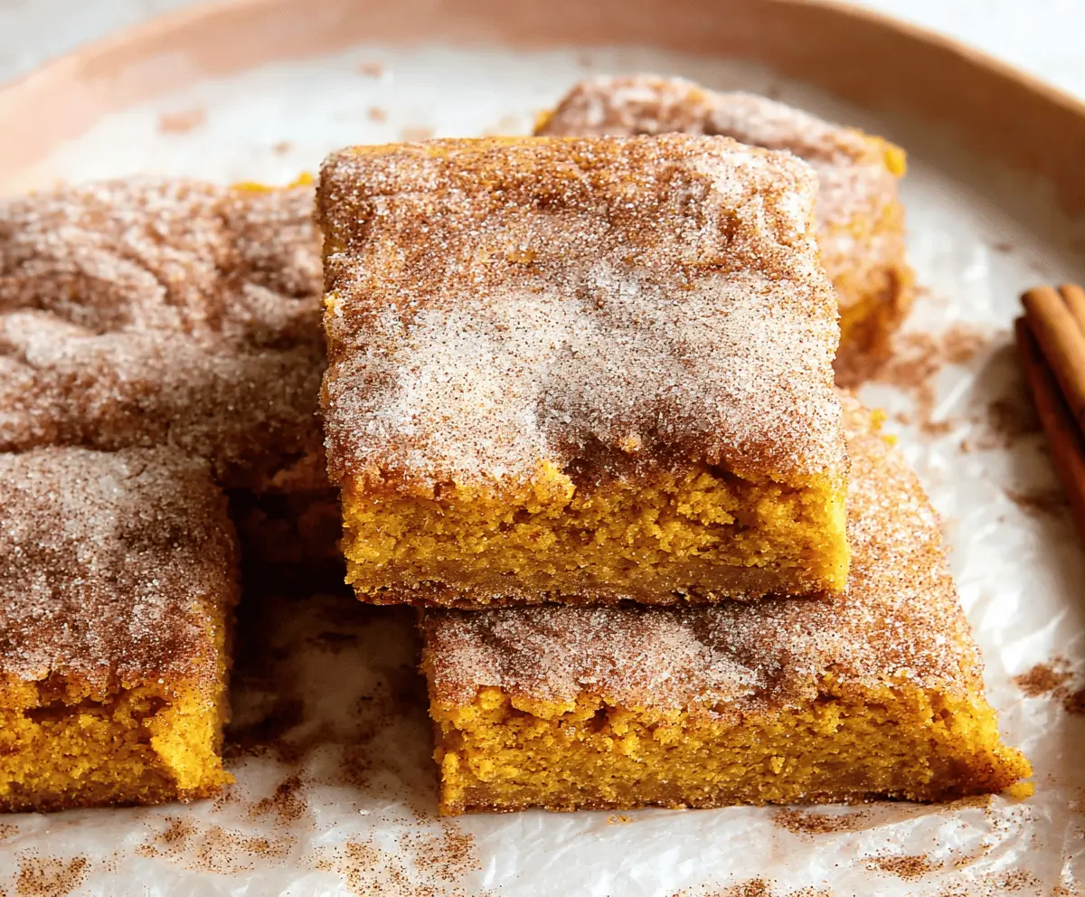 Delicious Pumpkin Snickerdoodle Bars topped with cinnamon sugar, perfect for fall baking and dessert cravings.
