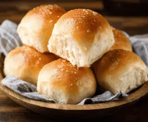 Melt-in-your-mouth soft dinner rolls fresh out of the oven, golden brown and fluffy.