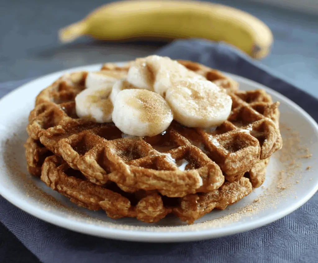 Delicious banana oatmeal waffles topped with fresh fruit ideal for breakfast or brunch.