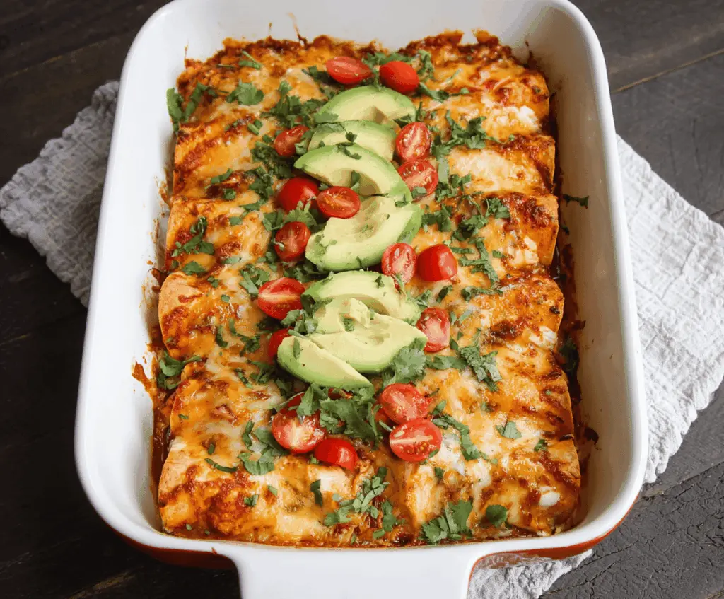 Delicious sweet potato and chicken enchiladas topped with melted cheese on a serving plate.