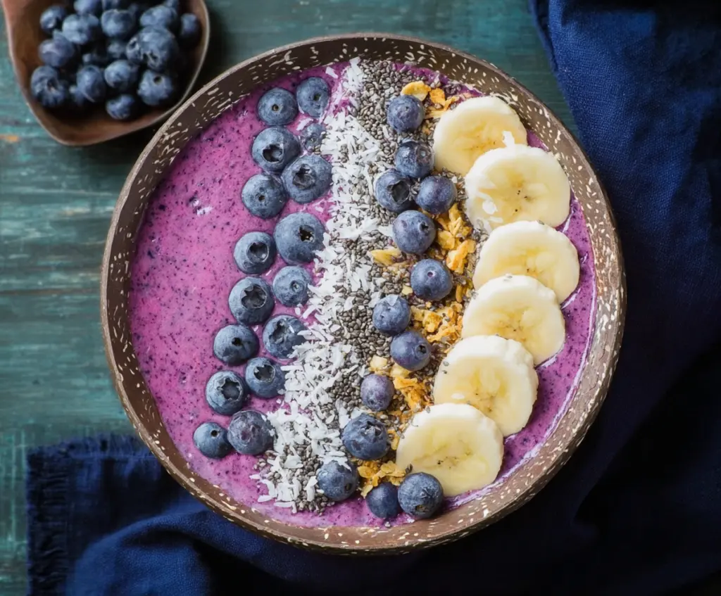 Delicious blueberry smoothie bowl topped with fresh fruits and granola for a healthy breakfast