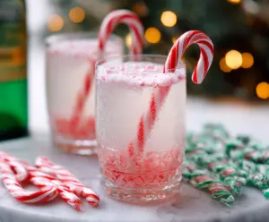Refreshing Candy Cane Spritzer Cocktail garnished with a candy cane and mint leaves, perfect for holiday celebrations