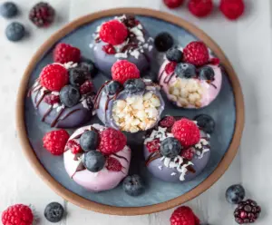 Delicious frozen Greek yogurt bites served with fresh fruit for a healthy snack.
