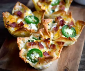 Delicious Jalapeno Popper Wonton Cups filled with creamy cheese and spicy jalapenos.