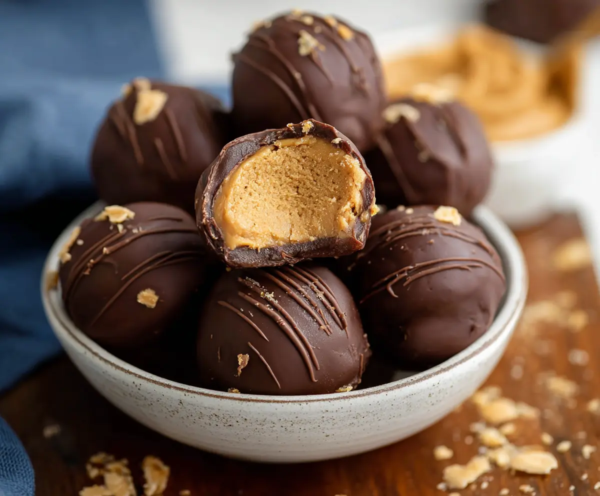 Delicious homemade peanut butter balls coated with chocolate on a serving plate