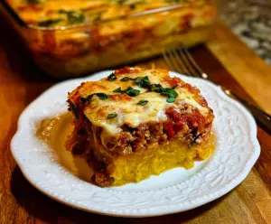 Delicious spaghetti squash lasagna with layers of melted cheese and fresh herbs.