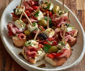 Close-up of Antipasto Bites featuring assorted cured meats, cheeses, and olives on a platter.