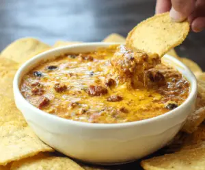 Delicious crockpot chili cheese dip served in a bowl with tortilla chips for a perfect appetizer.