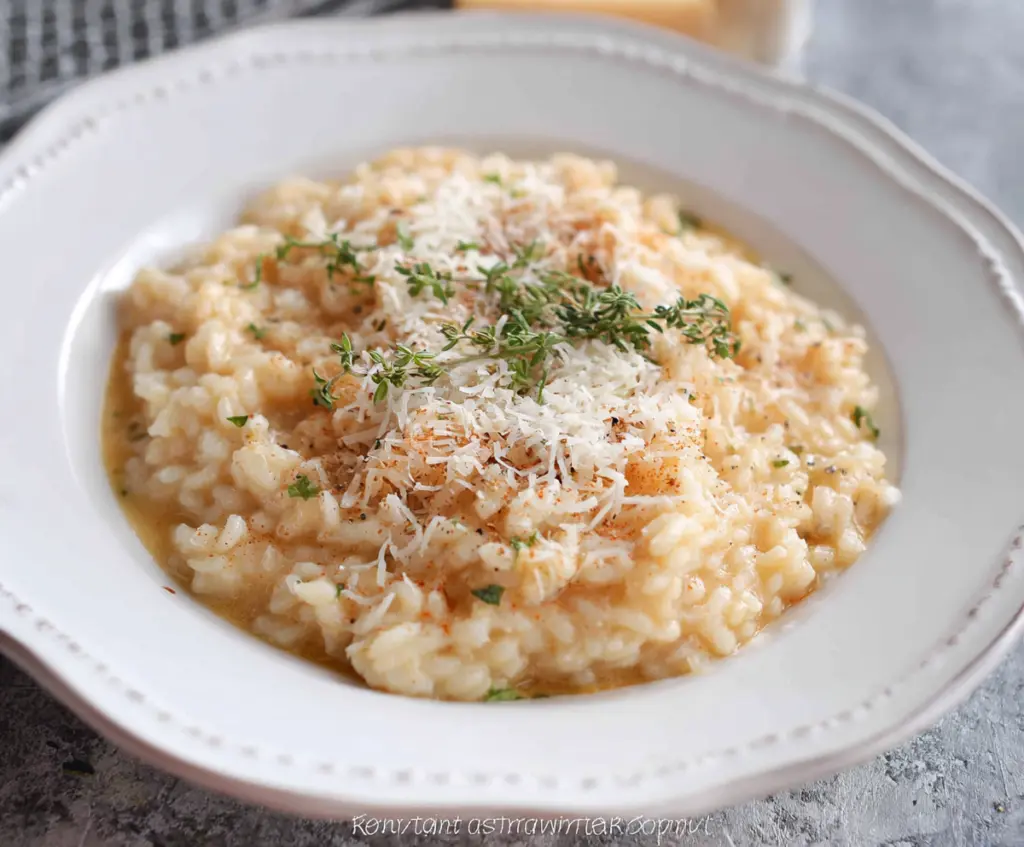Creamy Parmesan Risotto served in a bowl garnished with fresh herbs for a delicious Italian appetizer.